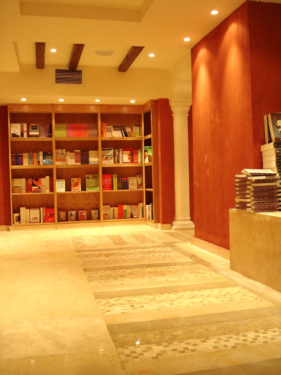 

<div style=color:#000>Location:Al-Zamalek, Cairo 
               Year:2010
               Status:Completed </div>
 The interior design theme is a continuation of the andalusian style that characterizes the bookstore chain. In this branch, which stretches over 2 floors, a central wooden staircase spiraling inside an illuminated glass cube lightens up the whole space beneath and connects both floors while it acts as a generator for chance encounters by remaining in a state of constant flux